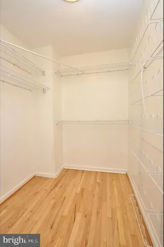 a view of a room with wooden floor and a window
