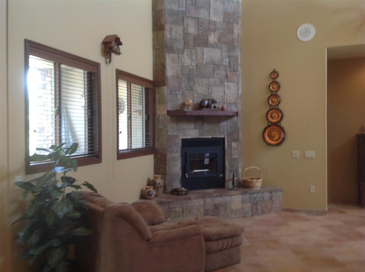 1092 South Hunters Run Show Low, AZ 85901 - Photo 13 of 36 a living room with furniture a window and a fireplace