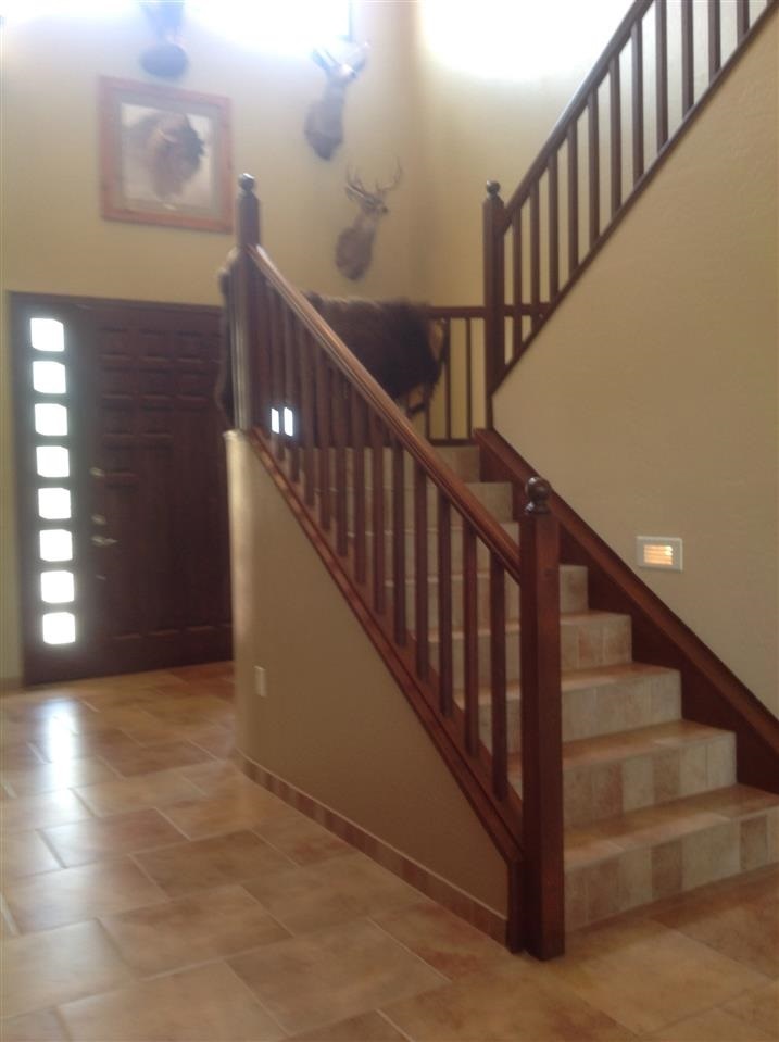1092 South Hunters Run Show Low, AZ 85901 - Photo 17 of 36 a view of staircase with lots of frames on wall and wooden floor
