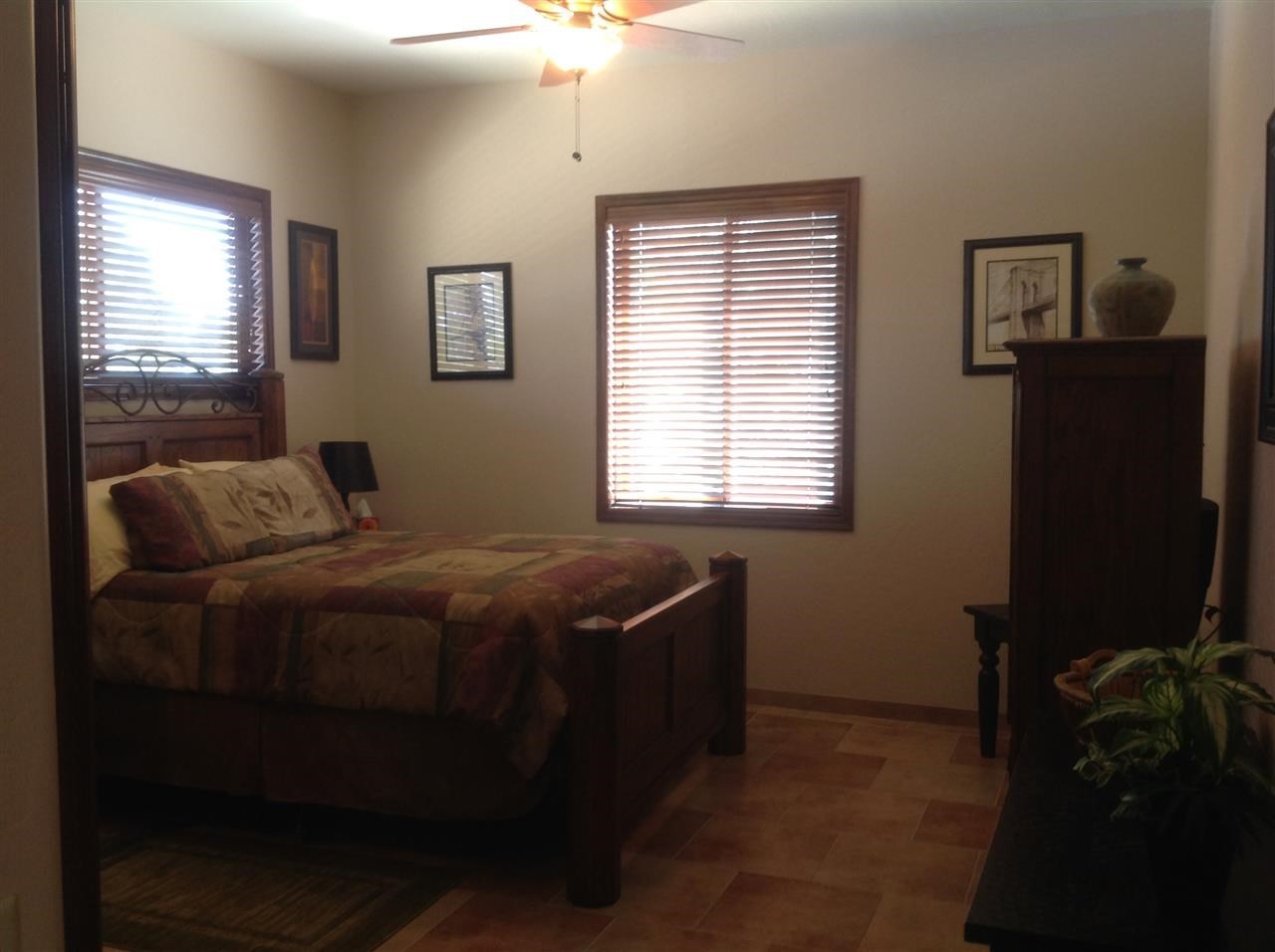 1092 South Hunters Run Show Low, AZ 85901 - Photo 22 of 36 a bedroom with a bed and a window