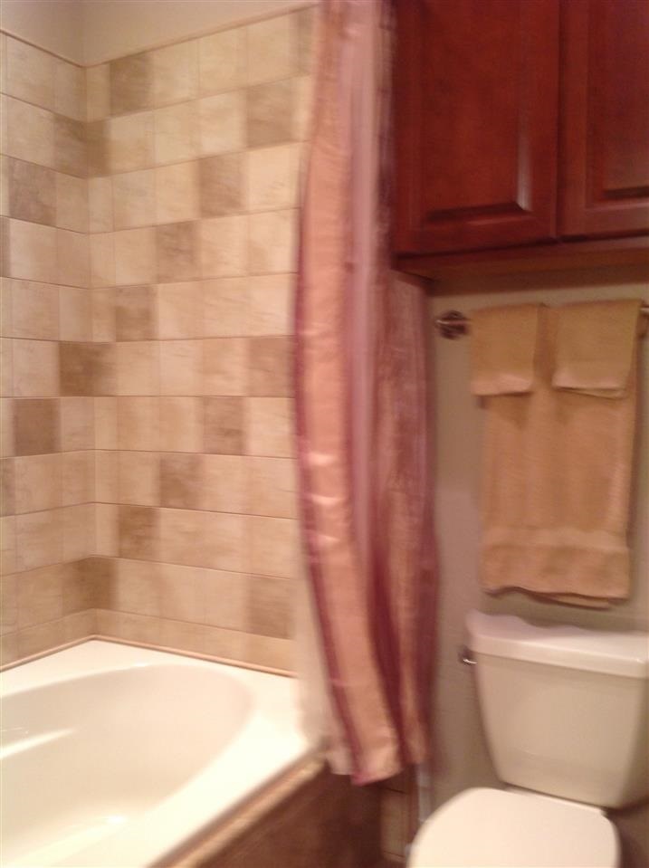 1092 South Hunters Run Show Low, AZ 85901 - Photo 26 of 36 a bathroom with a toilet and a shower curtain