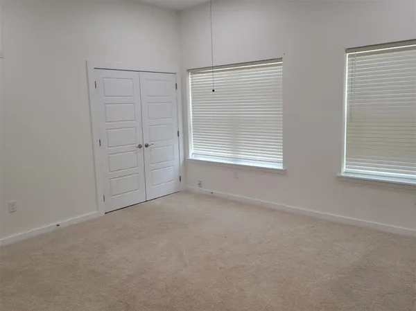 a bathroom with a granite countertop toilet sink and mirror