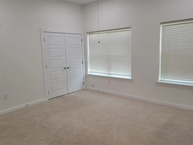a bathroom with a granite countertop toilet sink and mirror