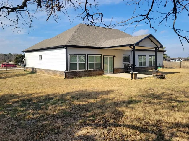 a large kitchen with a white stove top oven and white cabinets