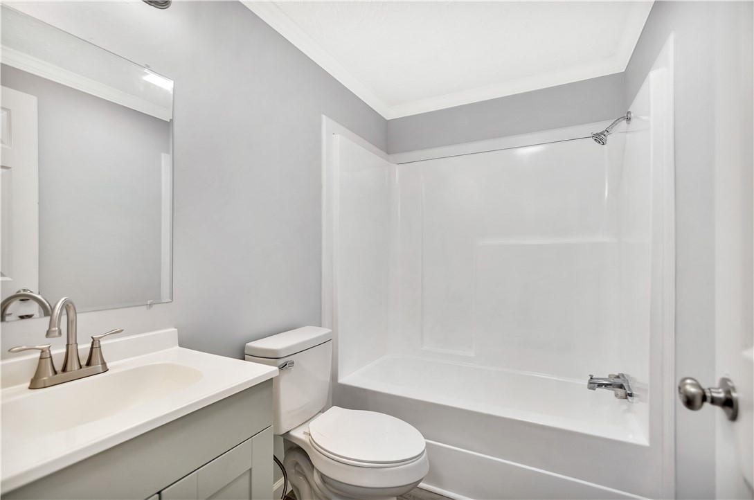 403 Hancox Place Westminster, SC 29693 - Photo 35 of 39 A well-appointed bathroom with a sleek vanity and a pristine shower-tub combination.
