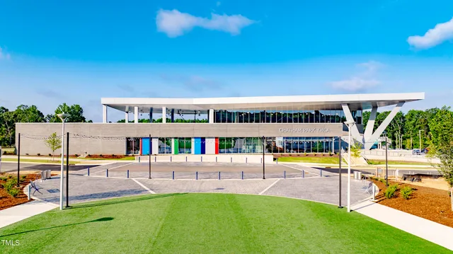 a view of a swimming pool with a patio and a yard