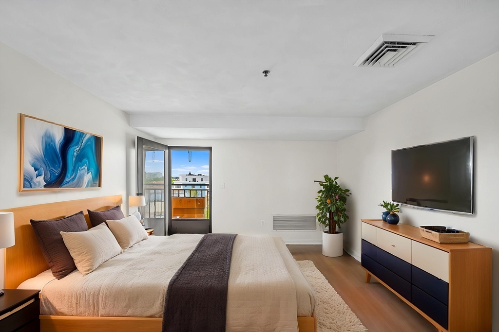 39 Parlin Street, Unit 503 Everett, MA 02149 - Photo 14 of 24 a bedroom with a bed and a flat screen tv