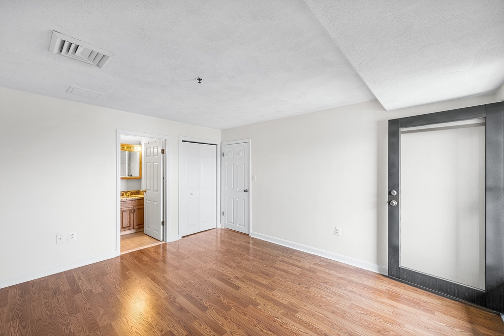 39 Parlin Street, Unit 503 Everett, MA 02149 - Photo 17 of 24 a view of empty room with wooden floor