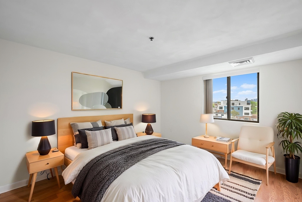 39 Parlin Street, Unit 503 Everett, MA 02149 - Photo 19 of 24 a bedroom with a bed and wooden floor