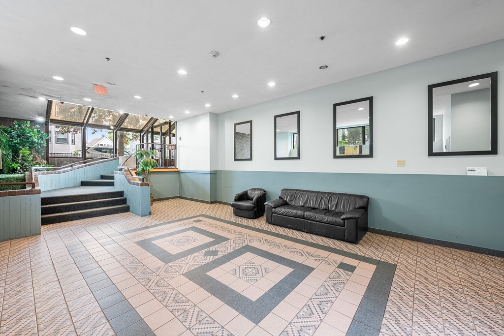 39 Parlin Street, Unit 503 Everett, MA 02149 - Photo 6 of 24 a bedroom with furniture and a rug