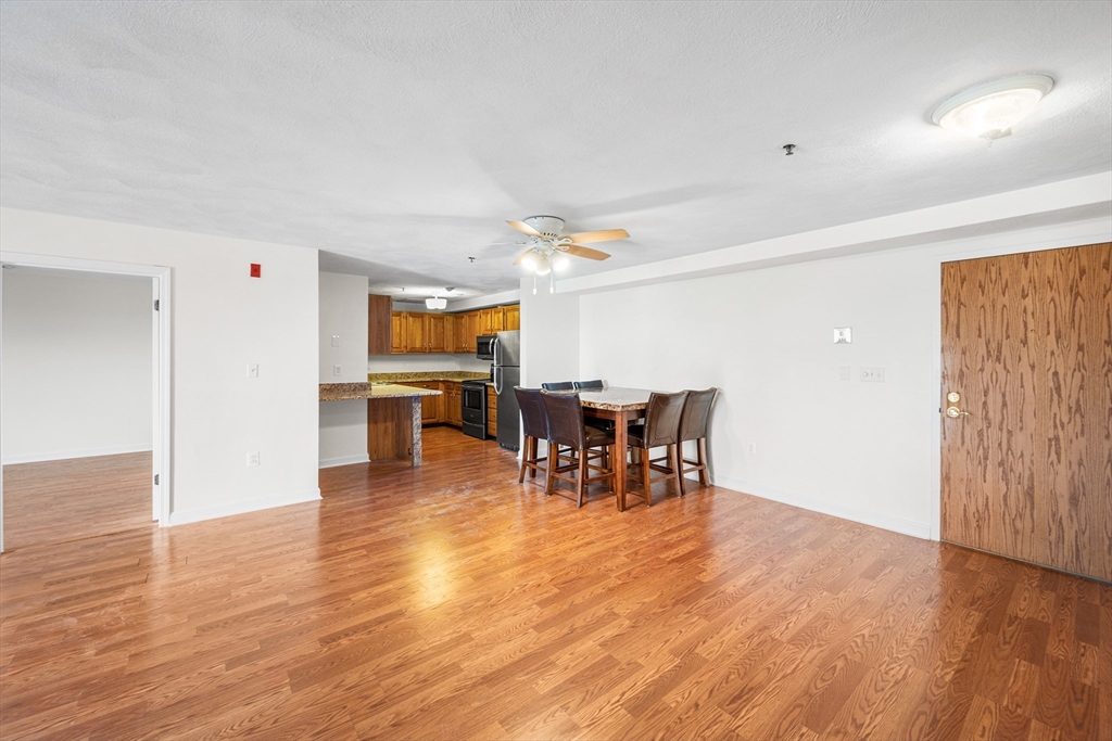 39 Parlin Street, Unit 503 Everett, MA 02149 - Photo 9 of 24 a view of a dining room with furniture and wooden floor