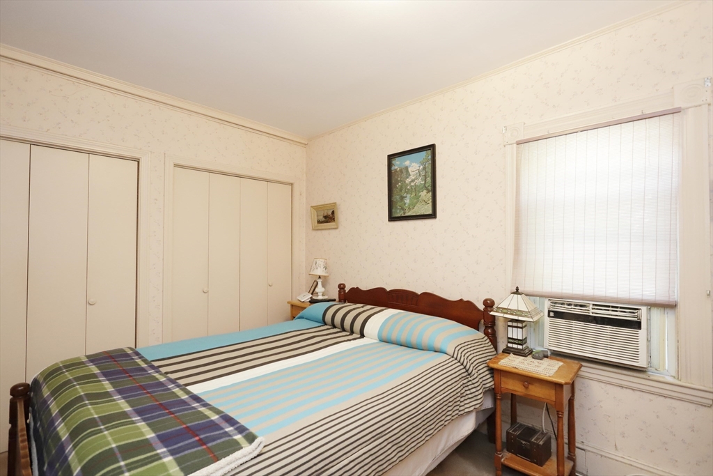 5 Anthony Street Acushnet, MA 02743 - Photo 27 of 37 a bedroom with a bed and a lamp on the dresser