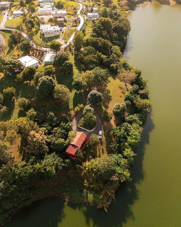 Lakefront Property Patillas, PR 00723 - Photo 1 of 1 an aerial view of a house with a yard and lake view