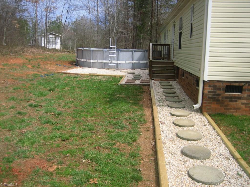 4738 Roundleaf Road Ramseur, NC 27316 - Photo 3 of 19 View of walkway to pool in back yard.