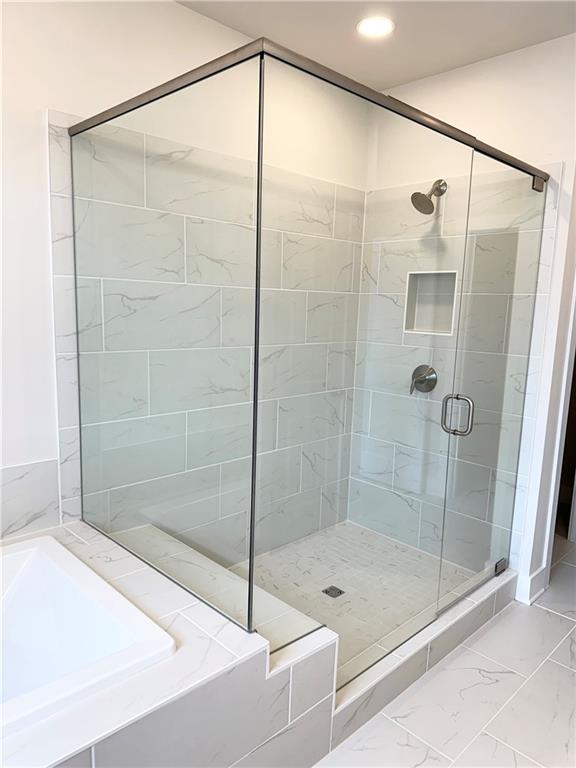 1237 Waldon Crossing Cumming, GA 30041 - Photo 15 of 29 a bathroom with a shower and a bathtub