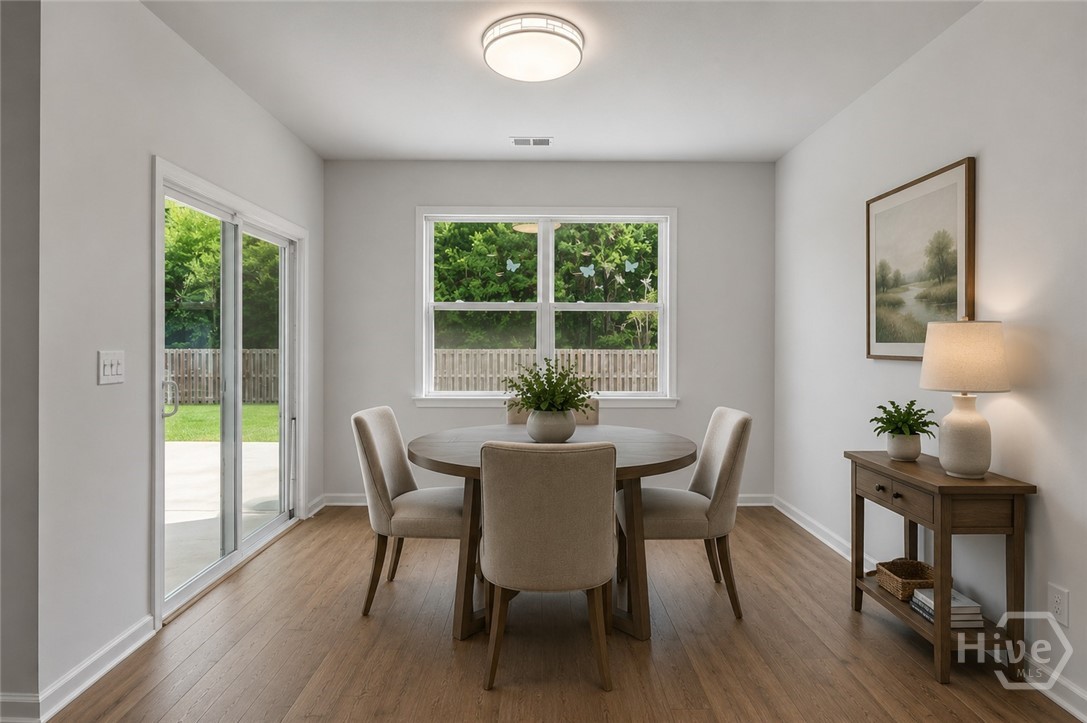 212 Sagefield Drive Rincon, GA 31326 - Photo 20 of 46 AI Staging, breakfast nook opening out to the private backyard with fence