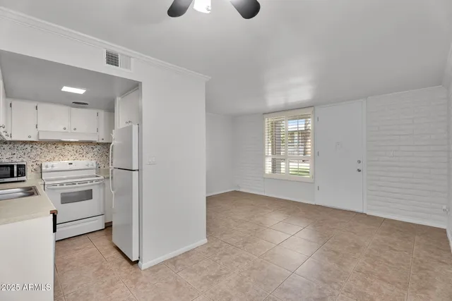 a kitchen with a sink stove and refrigerator