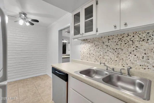 a view of a kitchen with a sink dishwasher and a refrigerator