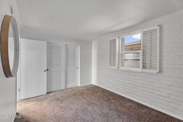 a view of a room with wooden floor and white walls