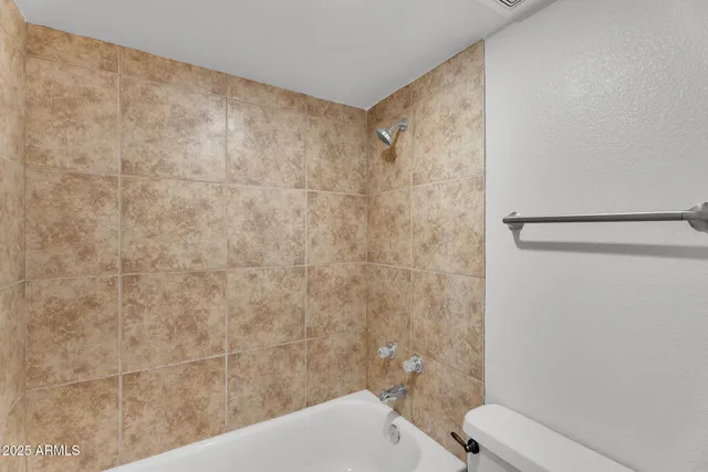 a bathroom with a glass shower door a bathtub a sink and a mirror