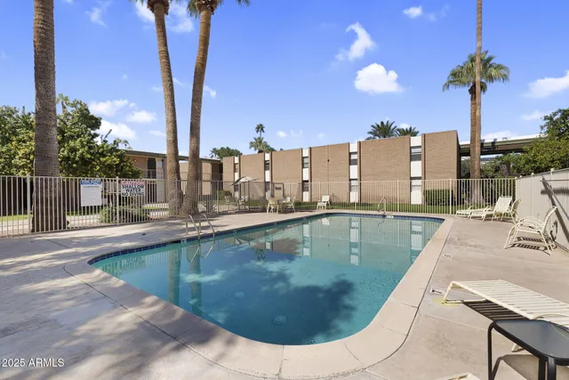 a view of a swimming pool with a lounge chairs