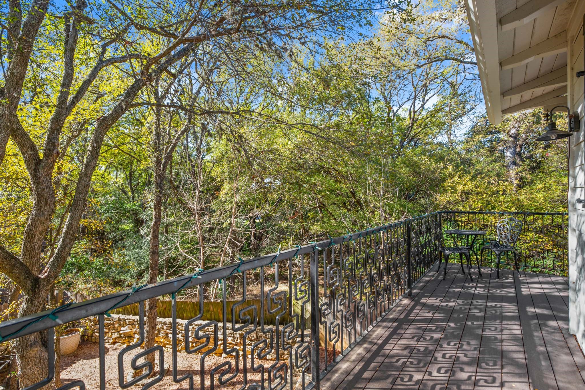 1601 Whitney Way Austin, TX 78741 - Photo 26 of 30 Perched above a verdant canopy, this elevated deck offers a peaceful, private outdoor retreat.