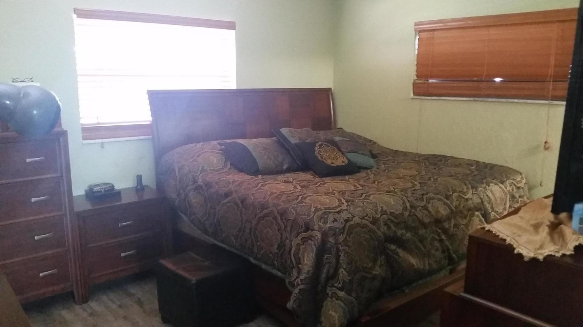 4693 Bison Street Boca Raton, FL 33428 - Photo 16 of 34 a bed sitting in a bedroom next to a window