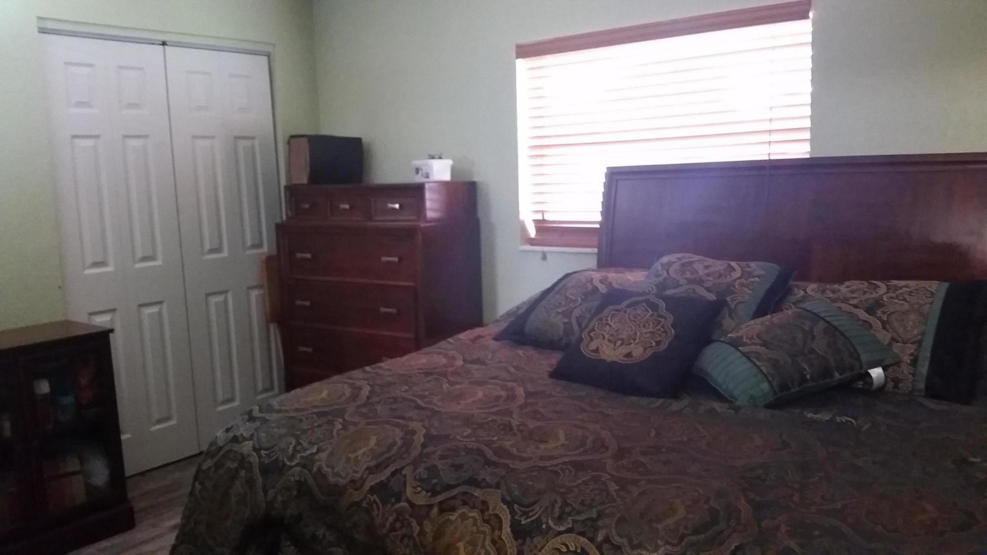 4693 Bison Street Boca Raton, FL 33428 - Photo 22 of 34 a bedroom with a bed and a window