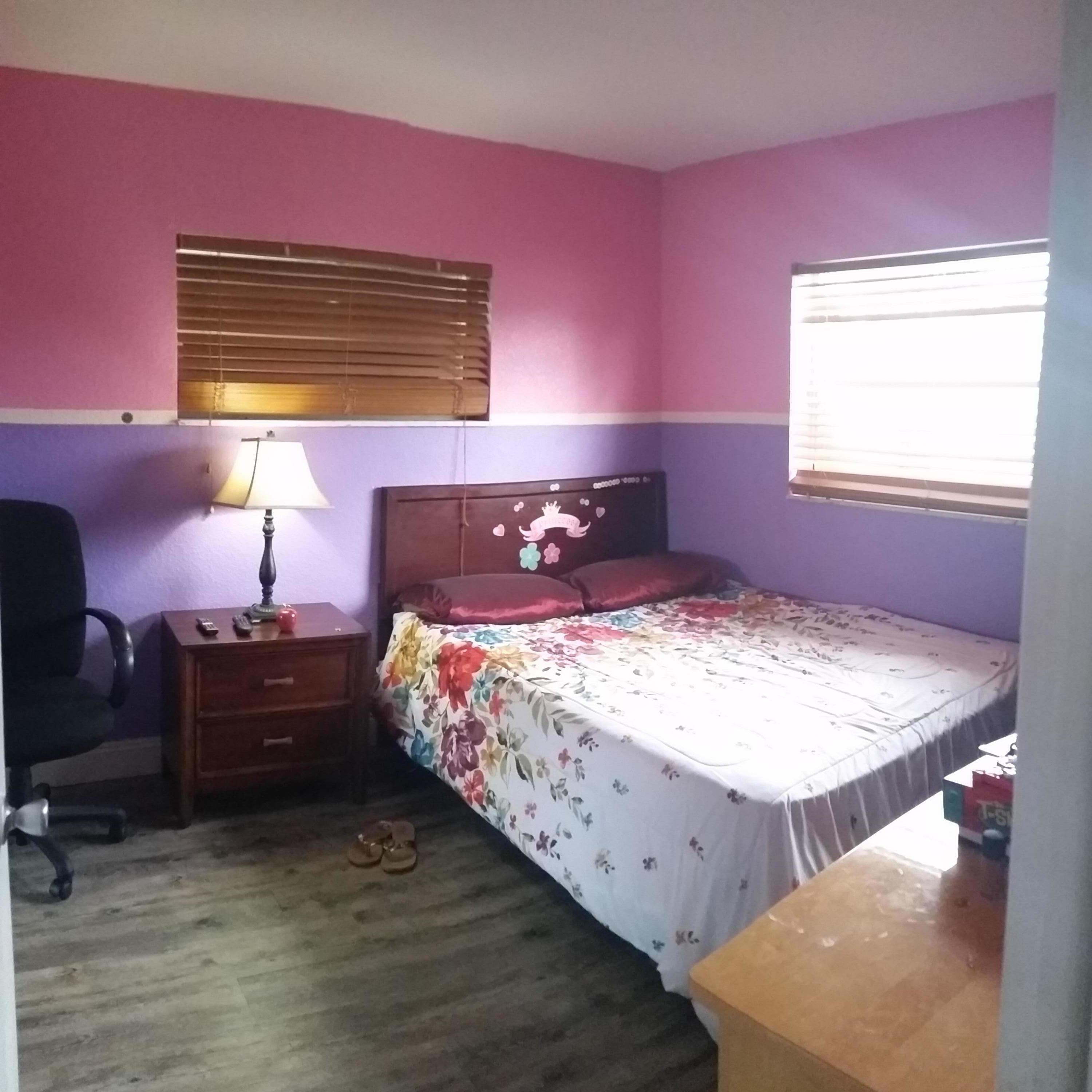 4693 Bison Street Boca Raton, FL 33428 - Photo 23 of 34 a bedroom with a bed and wooden floor