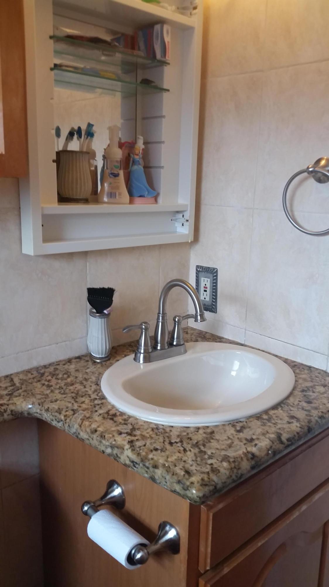 4693 Bison Street Boca Raton, FL 33428 - Photo 28 of 34 a bathroom with a granite countertop sink