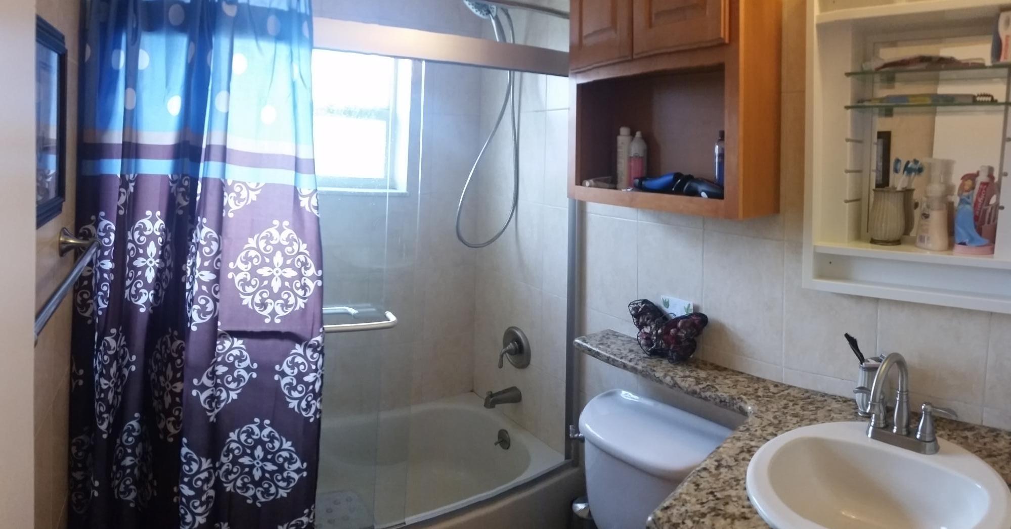 4693 Bison Street Boca Raton, FL 33428 - Photo 29 of 34 a bathroom with a sink toilet and shower