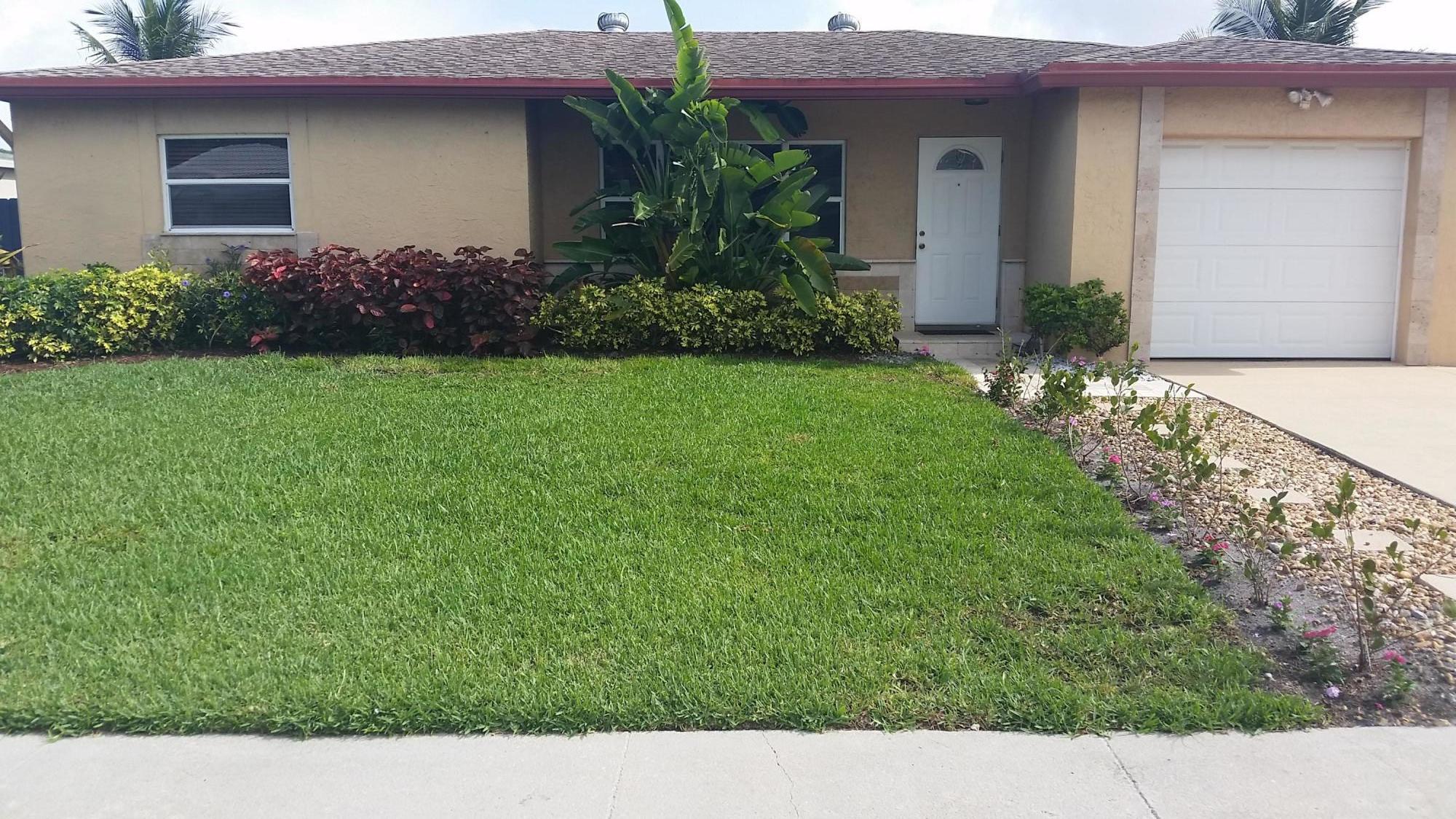 4693 Bison Street Boca Raton, FL 33428 - Photo 3 of 34 a view of a house with a garden