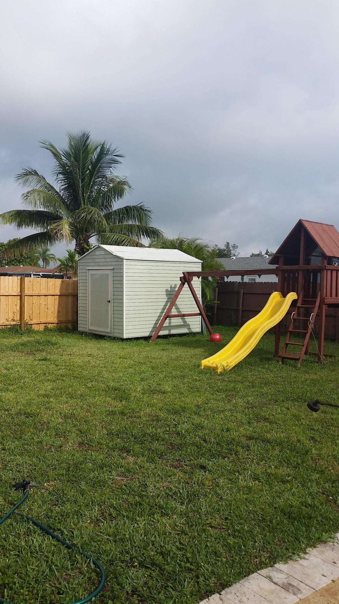 4693 Bison Street Boca Raton, FL 33428 - Photo 34 of 34 a view of a garden with a slide