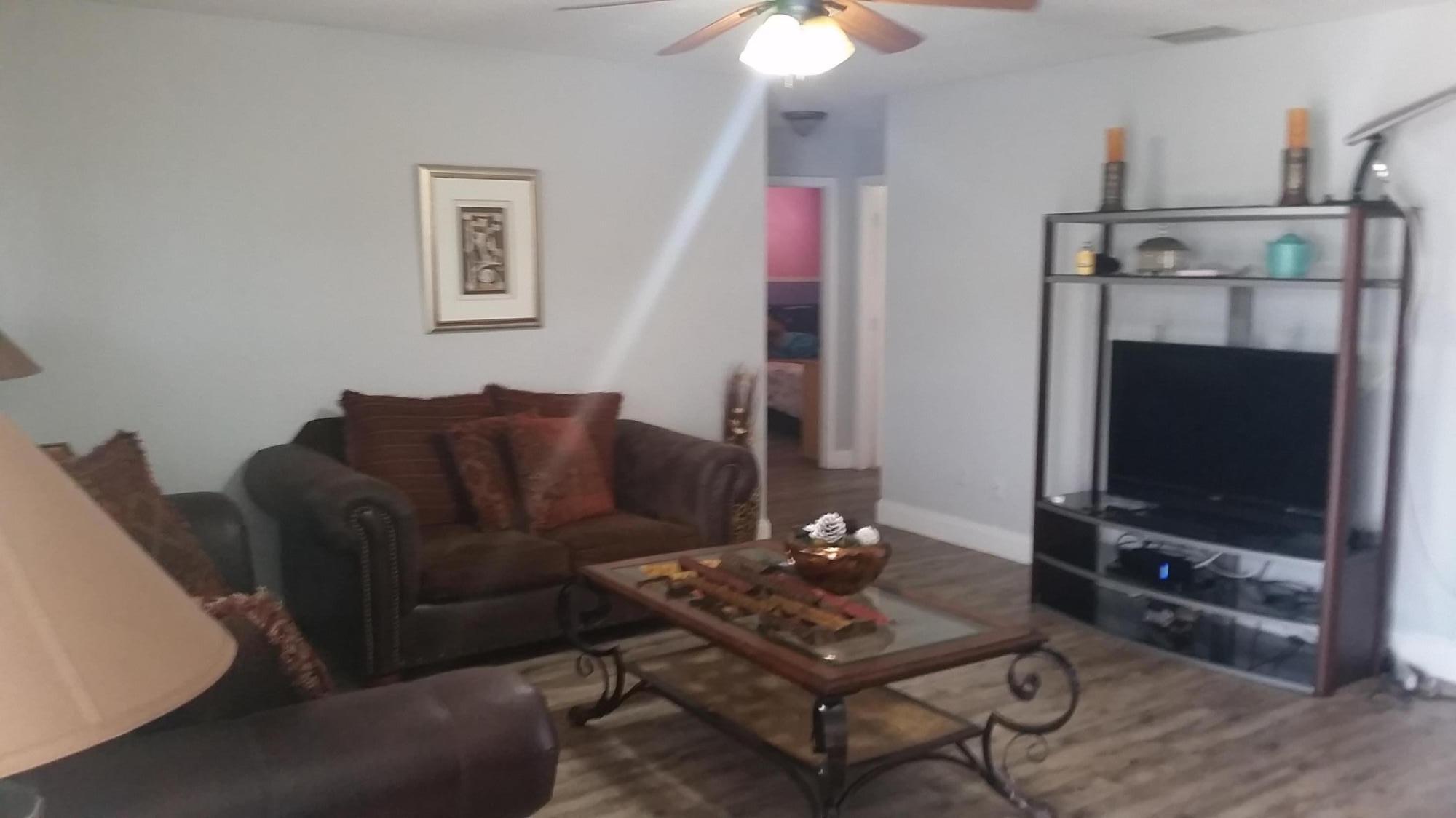 4693 Bison Street Boca Raton, FL 33428 - Photo 9 of 34 a living room with furniture a flat screen tv and a window