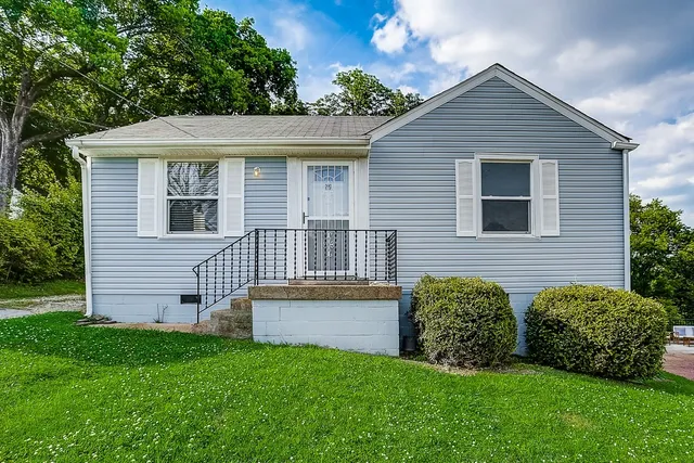 a view of front of house with a yard