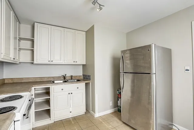 a white refrigerator freezer and a window