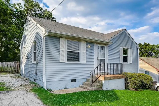 a view of a grassy field with trees