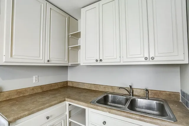 a kitchen with stainless steel appliances a refrigerator sink and cabinets