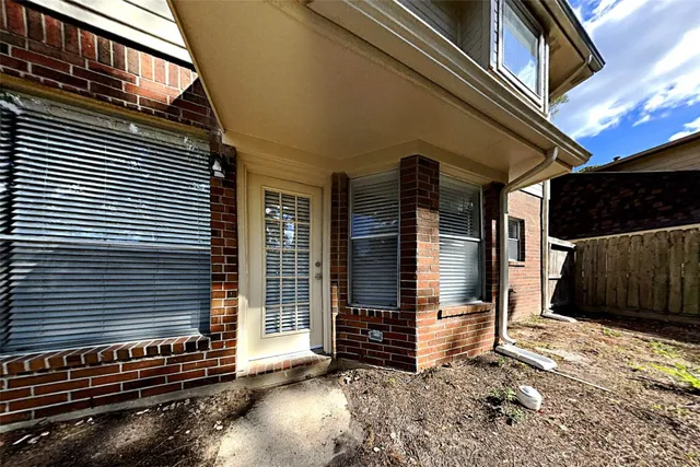 a view of brick house with a large window