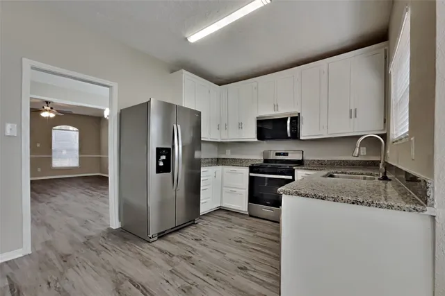 a kitchen with a refrigerator sink and microwave