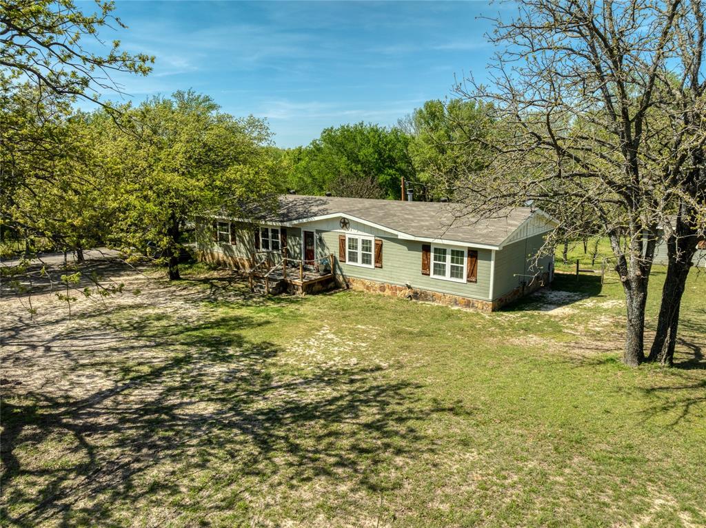 Aerial view of front of structure and front yard.