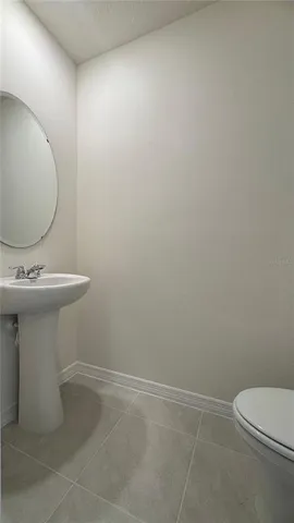 a bathroom with a sink toilet and a mirror