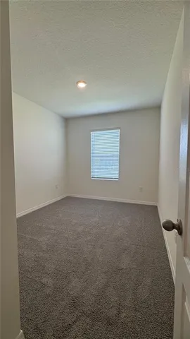 an empty room with a empty space and windows