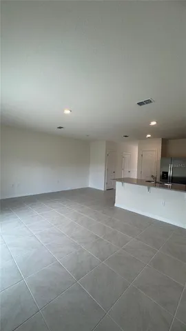 a view of a kitchen with kitchen island and a sink