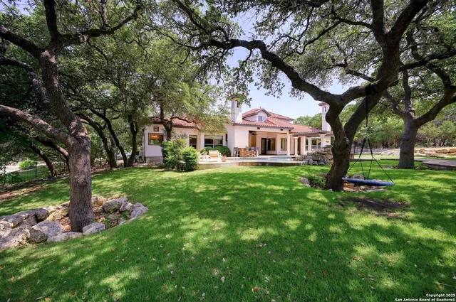 a roof deck with table and chairs a barbeque