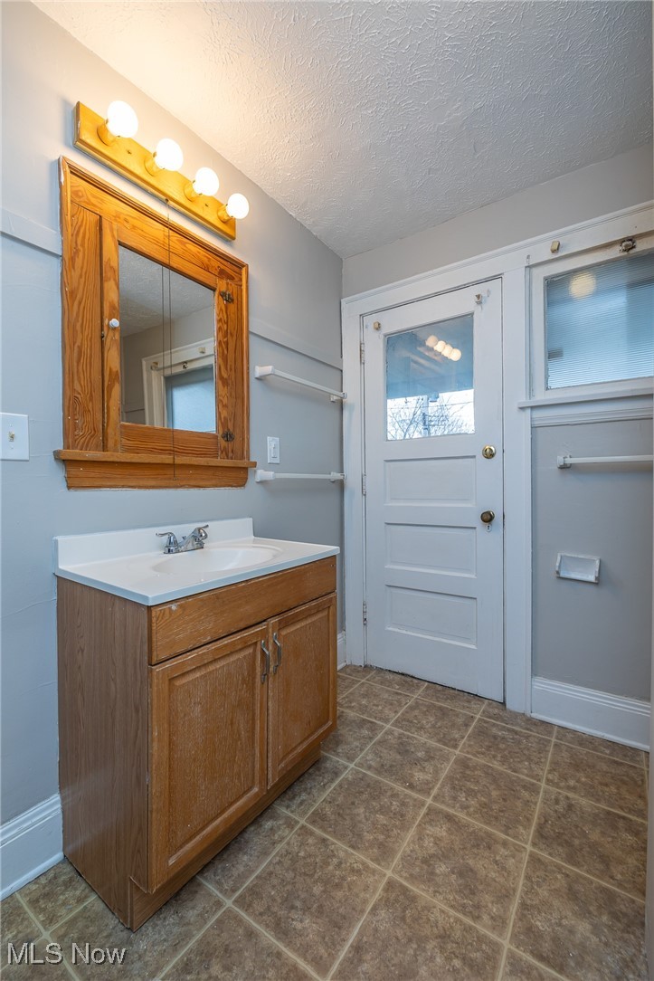 3396 Tullamore Road Cleveland, OH 44118 - Photo 12 of 23 Bathroom featuring vanity and a textured ceiling