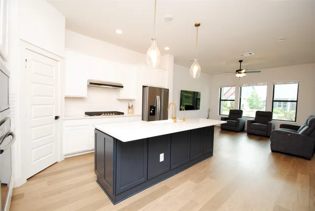 a kitchen with a refrigerator a stove and a sink