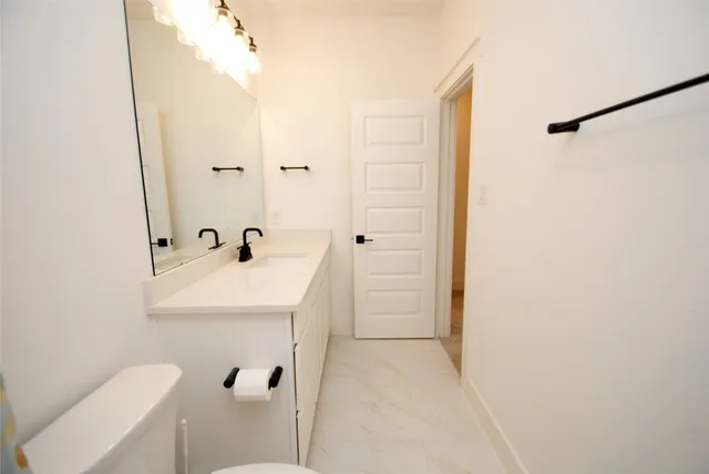 a bathroom with a double vanity sink mirror and shower