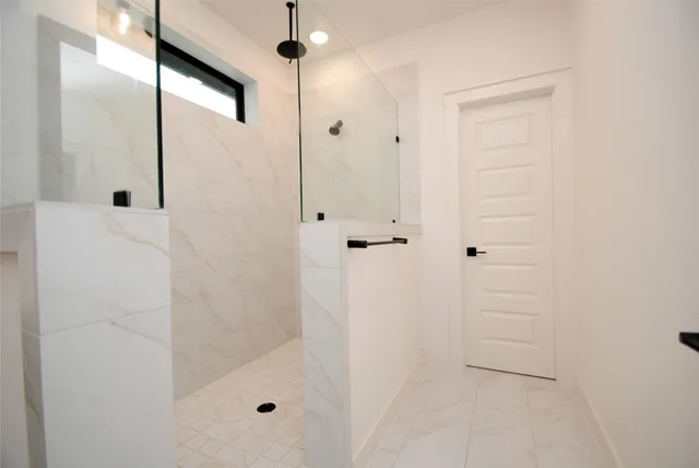a bathroom with a double vanity sink a mirror and shower