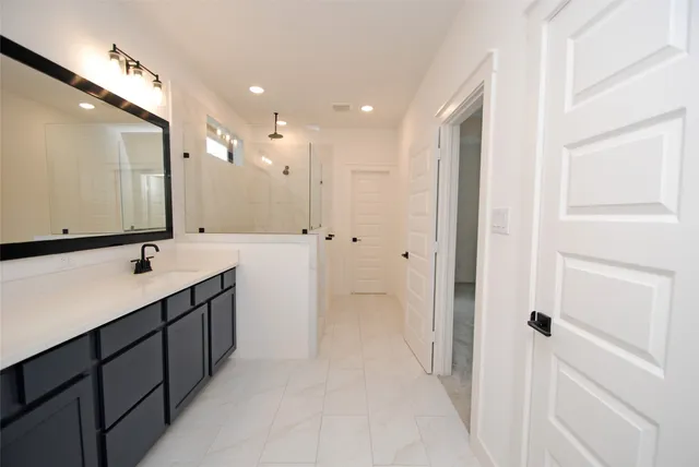a bathroom with a double vanity sink and mirror